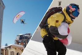 Redbull-paraglider vliegt op hoge snelheid door verlaten skiresort